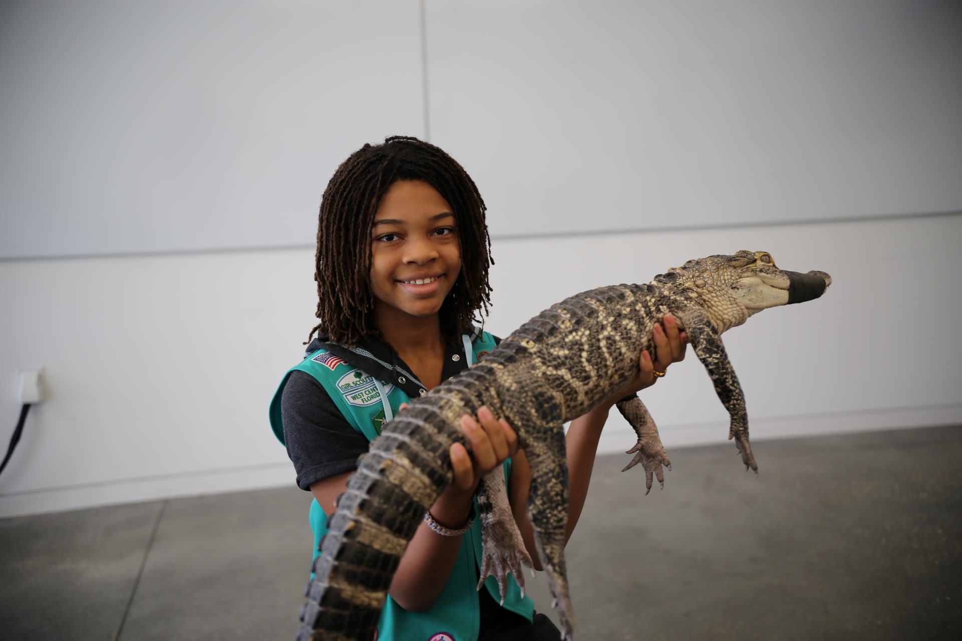  girl scout volunteer parent with young girl hiking outside at state park 