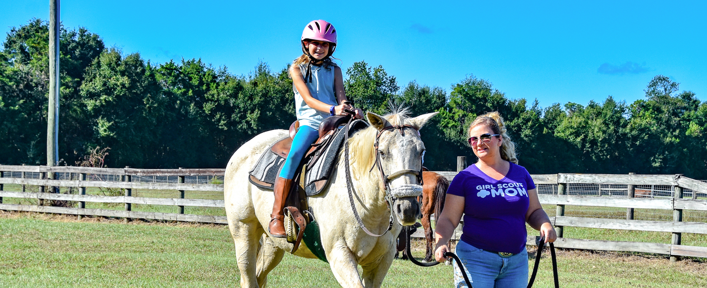  adult woman girl scout volunteer outdoors smiling 