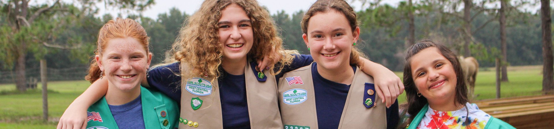  girl scout ambassador high school girl in school wearing sash with highest awards pins 