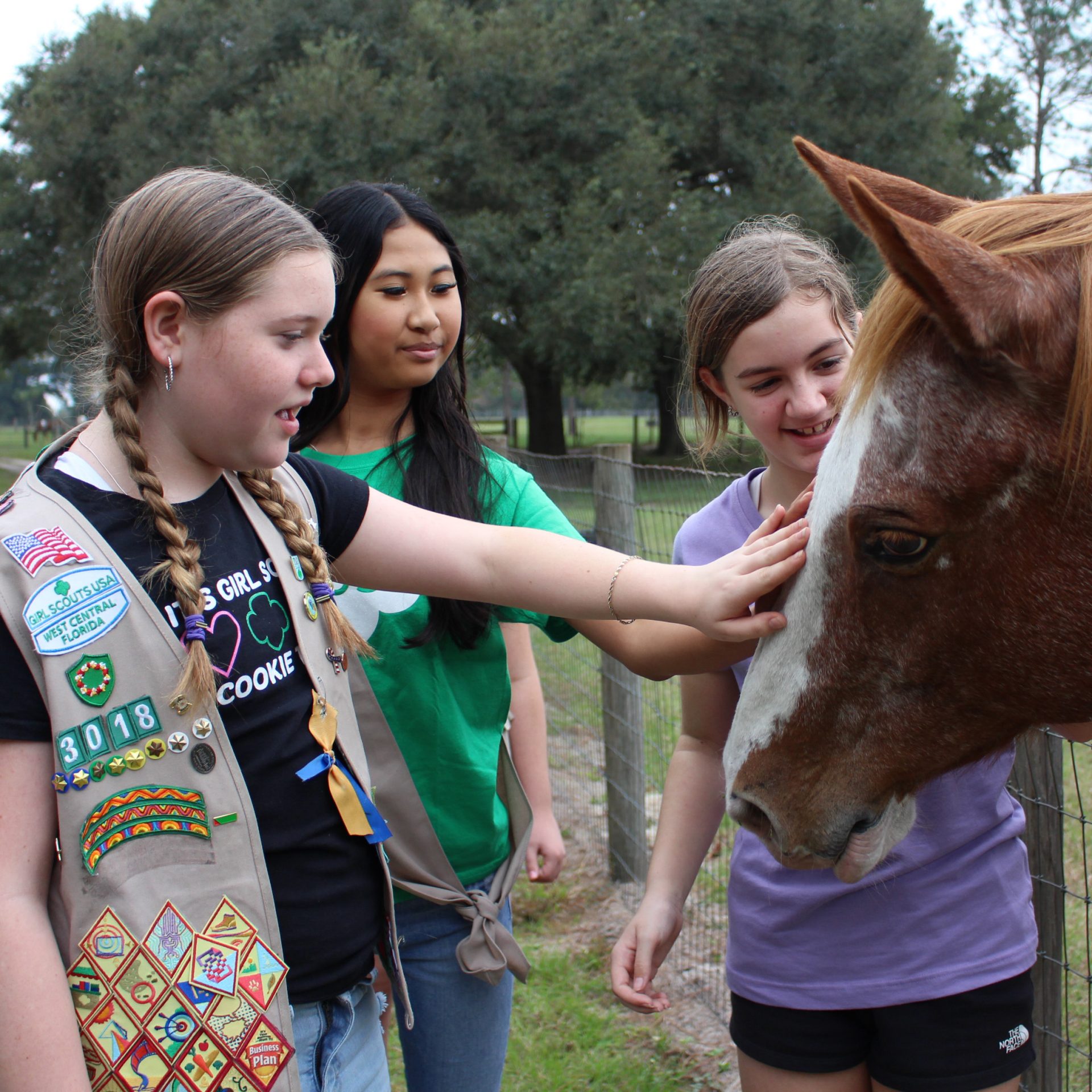 high school girl scout with tote bag outside at park or camp